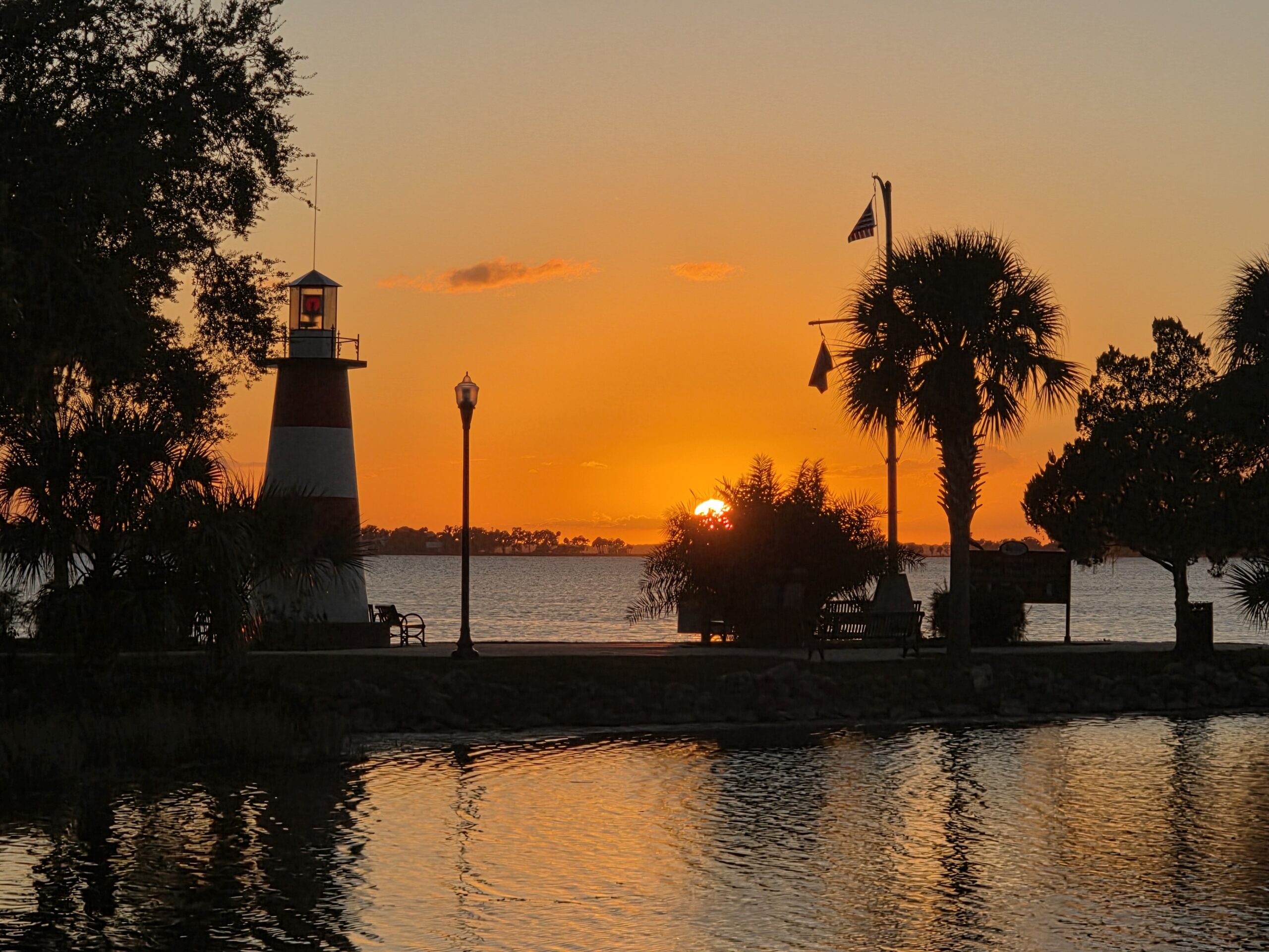 Sunset view of the Mount Dora Lighthouse and Lake Dora, featured in the guide to things to do in Mount Dora FL.
