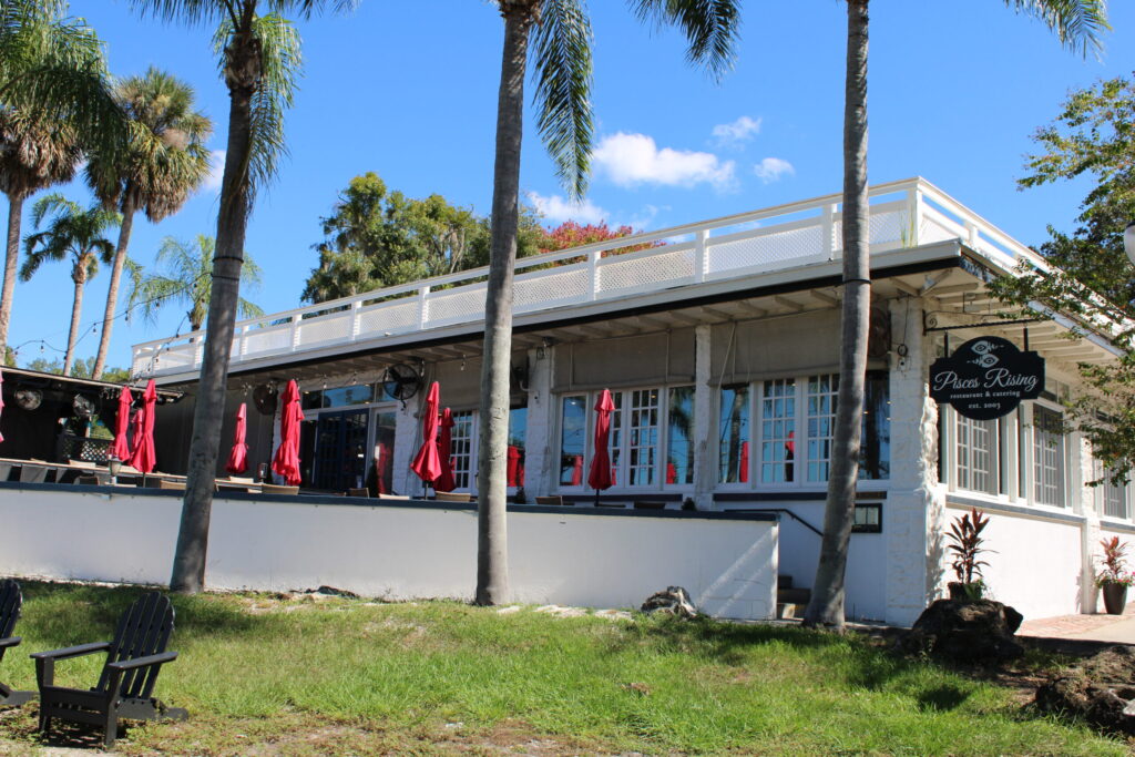 Outdoor dining patio at Pisces Rising restaurant overlooking Lake Dora in downtown Mount Dora, FL.